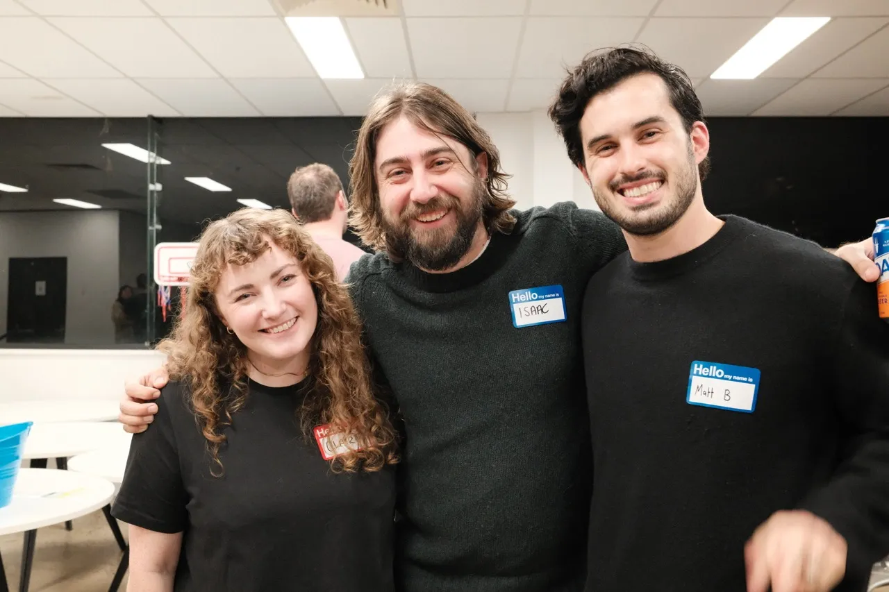 Three smiling guests together at an AI Ops meetup