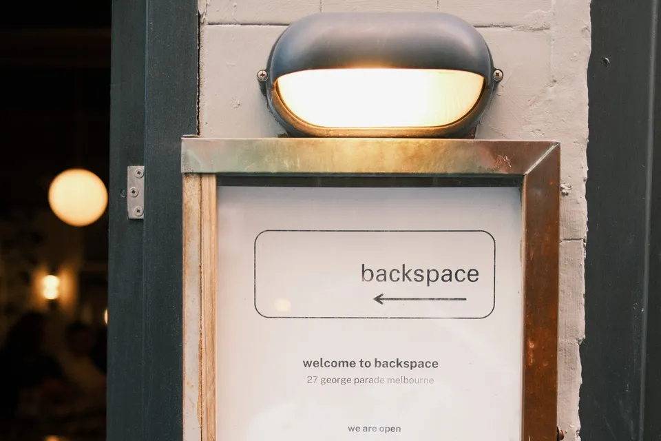 The illuminated Backspace venue entrance at AI Ops 008
