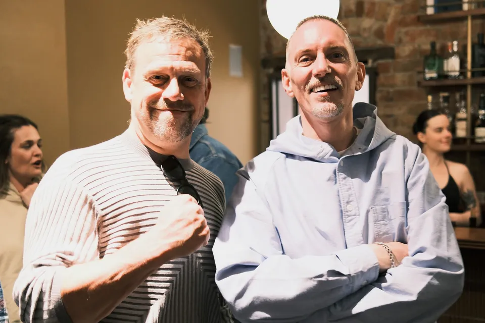 Two guests smiling together at AI Ops 008