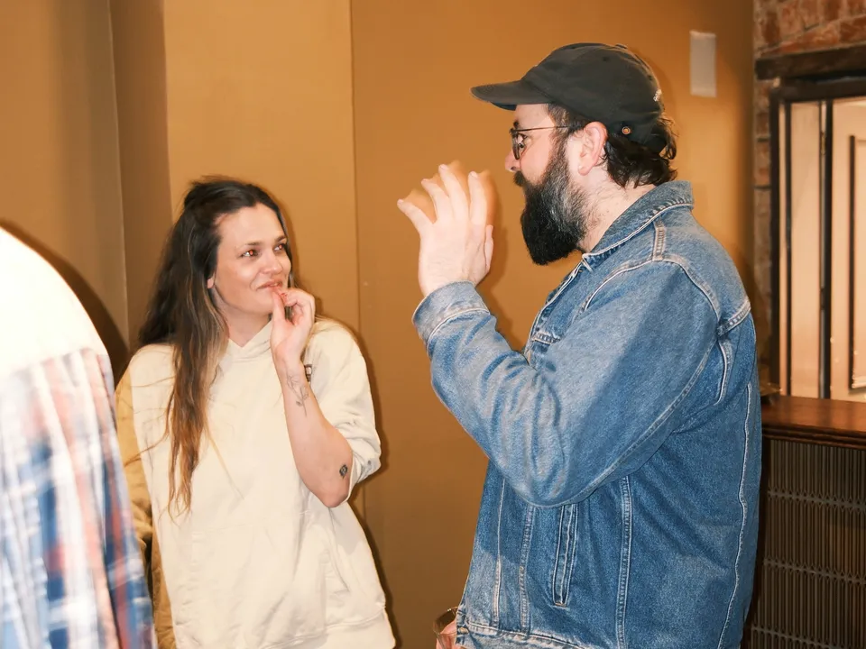 Two guests in an animated conversation at AI Ops 008