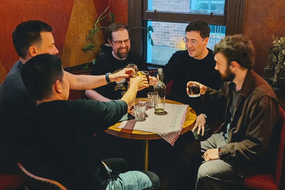 Guests sharing a toast around a table at AI Ops 008